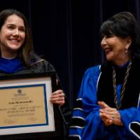 President with faculty holding award